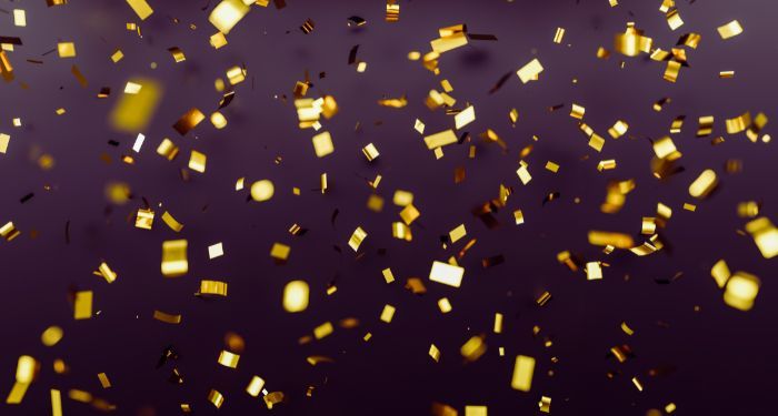 gold confetti against dark background